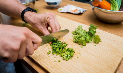 Chef at the kitchen preparing massaman curry with sweet potato and many spices
