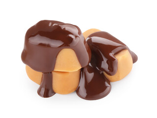 Delicious caramel candies with melted chocolate isolated on white