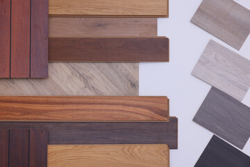 Many different samples of wooden flooring on light background