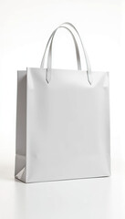 White shopping bag with handles standing upright on soft pink background ideal for branding retail packaging or promotional product display concept