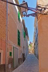 Image of a deserted street in a historic Spanish village at daytime