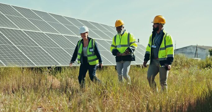 People, engineer and solar panel for eco friendly environment or alternative energy in nature. Group of employees, contractor or technician team walking for outdoor electrical installation in sun