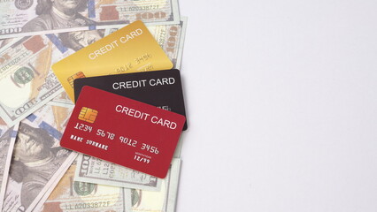 Credit cards and US dollars banknotes on white background.