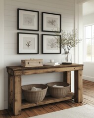 A rustic wooden console table with black picture frames on the wall above it
