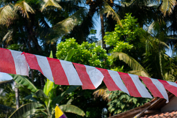 a small Indonesian flag made of plastic stretched out in the wind