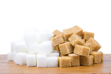 Sugar cubes on a wooden board, isolated on white background. Brown and white sugar.