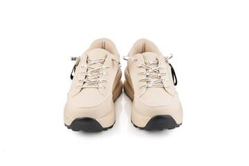 Beige women's sports shoes made of leather isolated on a white background. Beauty, fashion and sports.