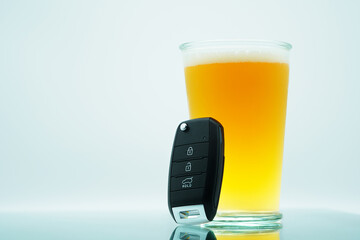 Drinking beer (alcohol) and driving. Car keys. Concept, choose sobriety, don't break the law