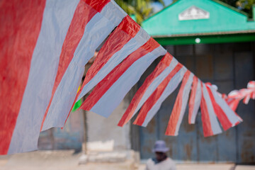 a small Indonesian flag made of plastic stretched out in the wind