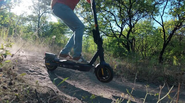 Extreme downhill on an electric scooter on a country road in slow motion