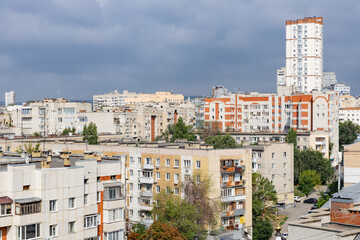 Summer urban landscape. Apartment buildings. Architecture of the city of Saratov, Russia. Clouds in the sky.