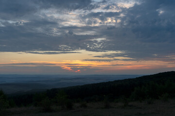 Sunrise over city and mountains 