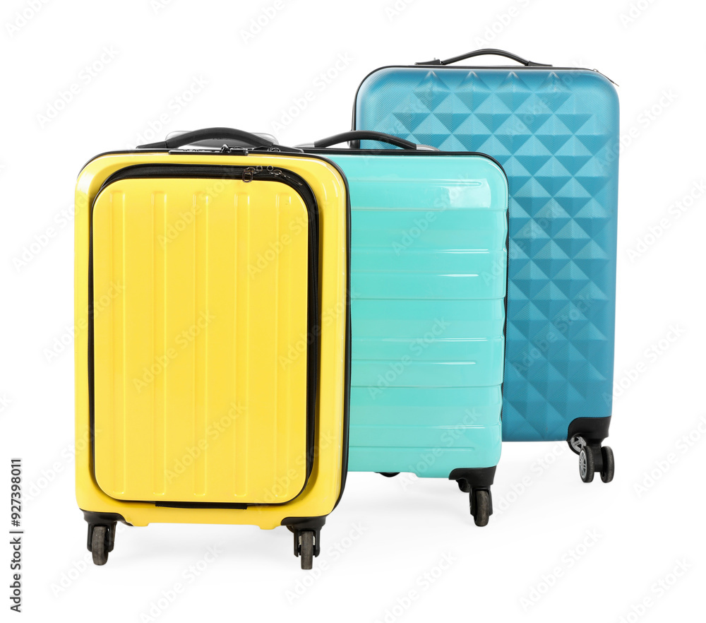 Wall mural New yellow and light blue suitcases isolated on white