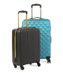 Two new light blue and black suitcases isolated on white