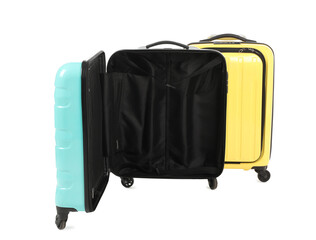 Two yellow and light blue suitcases isolated on white