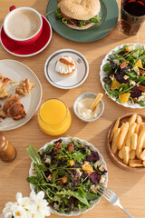 The lifestyle of gourmets. Different dishes on a wooden table. The concept of lunch, restaurant