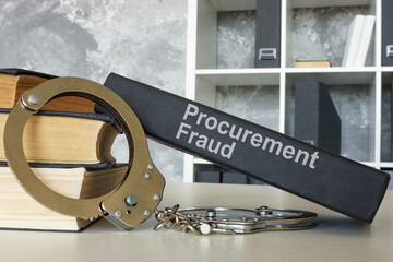Books about procurement fraud and handcuffs. Legal consequences concept.