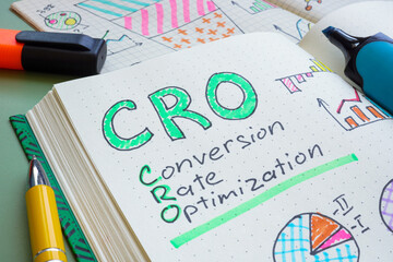 Open notebook with the text CRO Conversion rate optimization. Digital marketing strategy and...