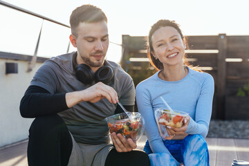 Man and woman on urban break with healthy food , conversation or health and wellness