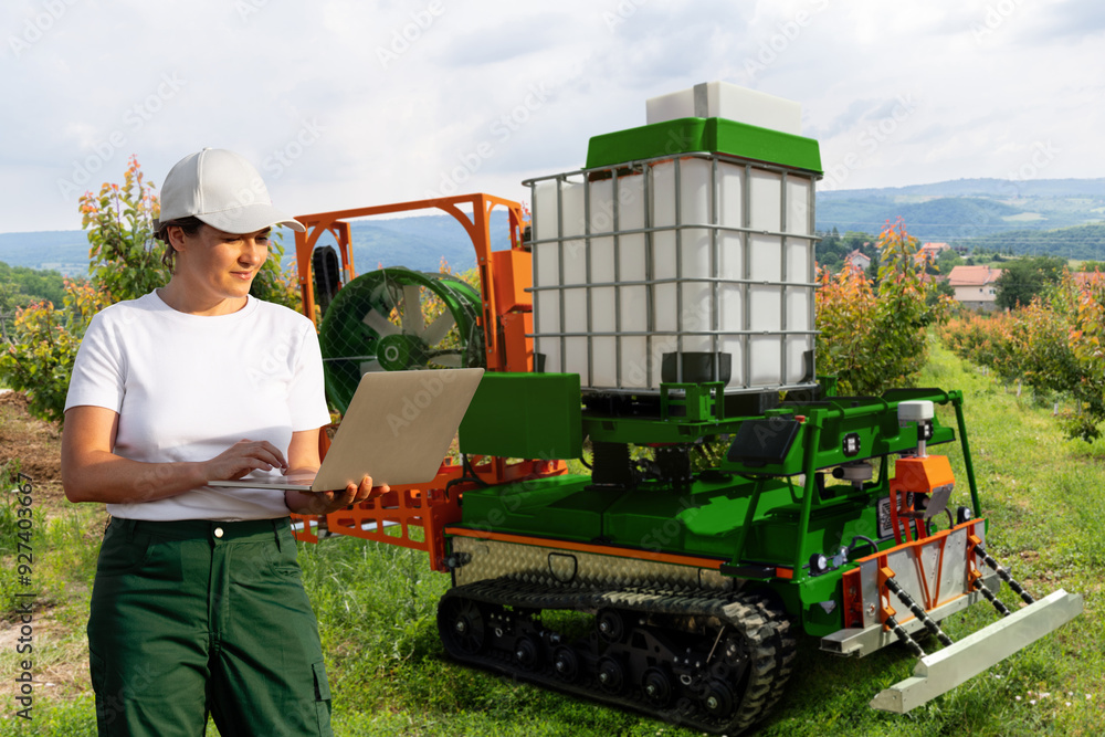 Poster farmer controls autonomous robot sprayer in a fruit garden. smart farming concept.