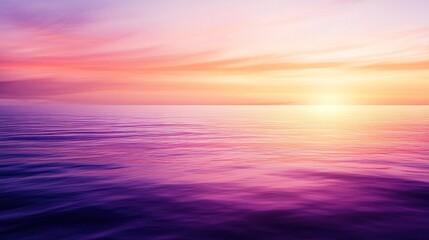 Obraz premium Calm ocean at sunset with vibrant purple and orange sky over still waters