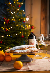 Christmas Stollen, Christmas still life with a Christmas tree and garlands, a laid Christmas table.