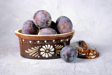 Ripe plums on a light background