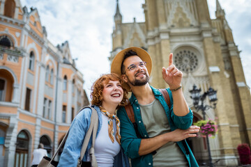 Couple exploring the city. Boyfriend showing his girlfriend