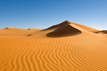 Stunning desert landscape with sand dunes under a clear blue sky, showcasing the beauty of nature and the calm of the dry, arid environment.