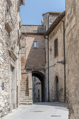 Fototapeta premium old stone houses on bending lane at medieval hilltop little town, Narni, Italy