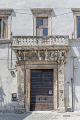 monumental travertine portal of historical building, Narni, Italy