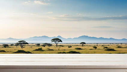 Fototapeta premium Empty the top of white wooden table for produst display with blurred a landscape african wildlife background