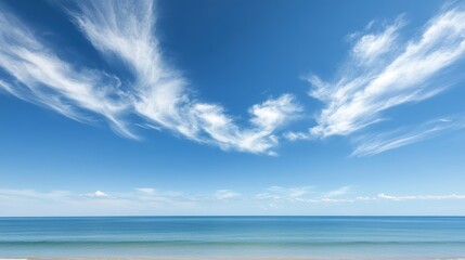 Fototapeta premium Tranquil Beach Bliss - Clear Sky and Wispy Clouds Over Horizon