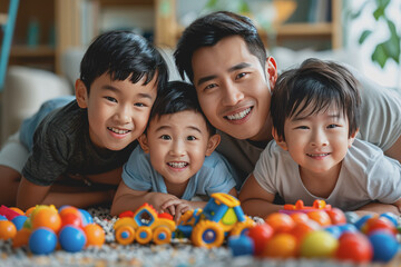 Fototapeta premium A father happily teaches his children to play with toys inside the house.