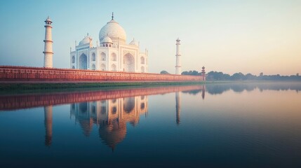 A serene view of the Taj Mahal, India, with its reflection shimmering in the river below. The bright daylight enhances the white marble, creating a stunning contrast with the clear sky