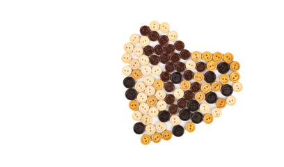 Heart from different wooden buttons on a white background