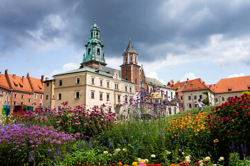 KRAKOW, POLAND - July 20, 2023: Summer view of Wawel Royal Castle complex in Krakow, Poland. It is the most historically and culturally important site in Poland. Flowers on a foreground