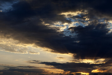 Fototapeta premium Storm sunrise sky with sun and rays