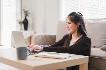 Happy Asian woman working from home.
