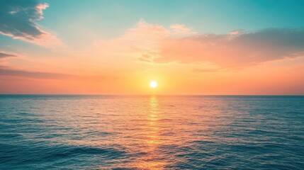 Obraz premium Sunset over the ocean with Peach Fuzz hues warm colors blend with the water creating a serene and captivating scene perfect for landscape photography