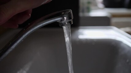 Man hands under a running faucet. Close up.