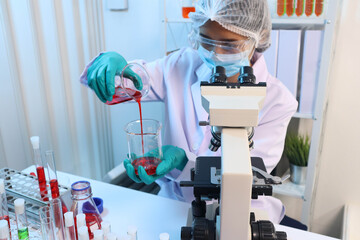 Scientists are testing medical drugs on a lab table.