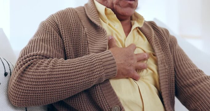 Senior man, chest pain with hand, heart attack and heath issue, emergency and discomfort. Medical, retired and sick with stress, asthma and ache for healthcare, injury and couch with heartburn