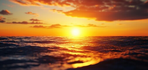 Fototapeta premium A stunning sunset over calm ocean waters, showcasing vibrant colors and serene waves, perfect for relaxation and tranquility.