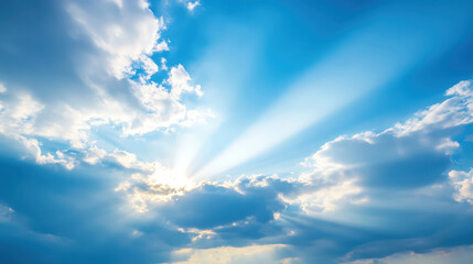 Obraz premium Sun Rays Shining Through Clouds in a Clear Blue Sky