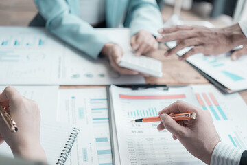 Business meeting, various international executives discuss reports at the meeting table, project negotiation committee develops business strategies by analyzing documents, graphs, close-up images.