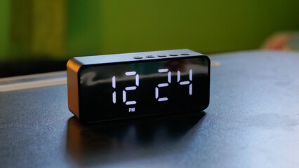 Modern aesthetic digital clock on black table with diffuser behind it