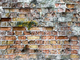 an old dilapidated brick wall of red brick