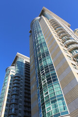 modern office building and apartments on a blue sky background
