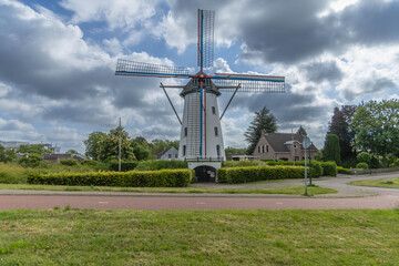 Windmill 't Nupke Geldrop a dutch village with heavy clouds in the background. Built in 1843 on a hill, the windmill functioned as a gristmill.